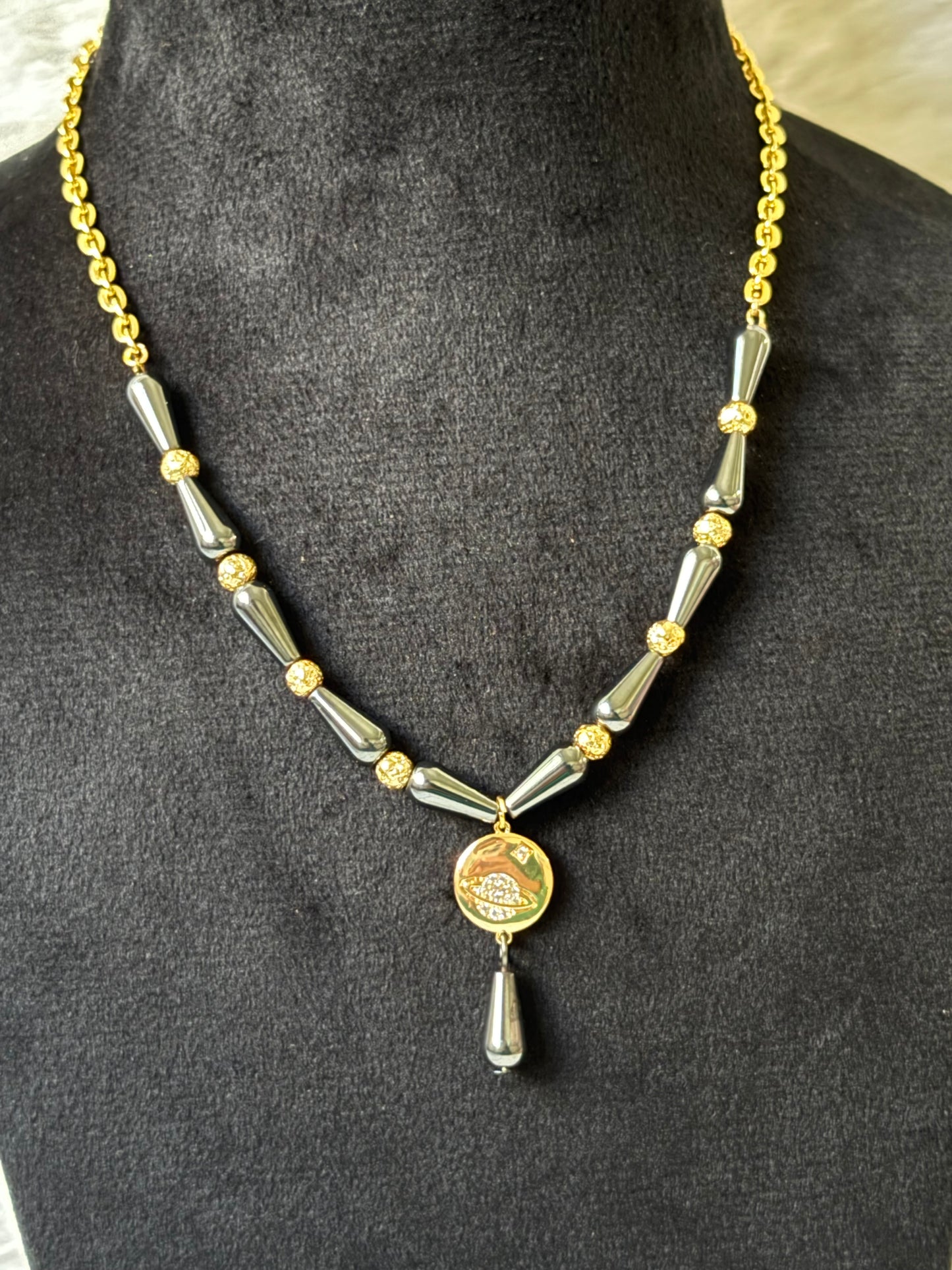 Saturn necklace with black beads