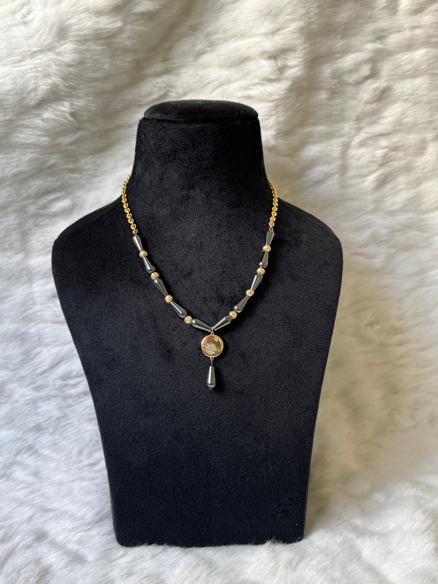 Saturn necklace with black beads