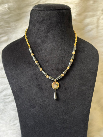 Saturn necklace with black beads